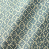 Fabric sample of a blue and neutral printed linen fabric with a geometric pattern