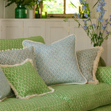 Sofa upholstered in a green and neutral printed linen fabric with a geometric pattern