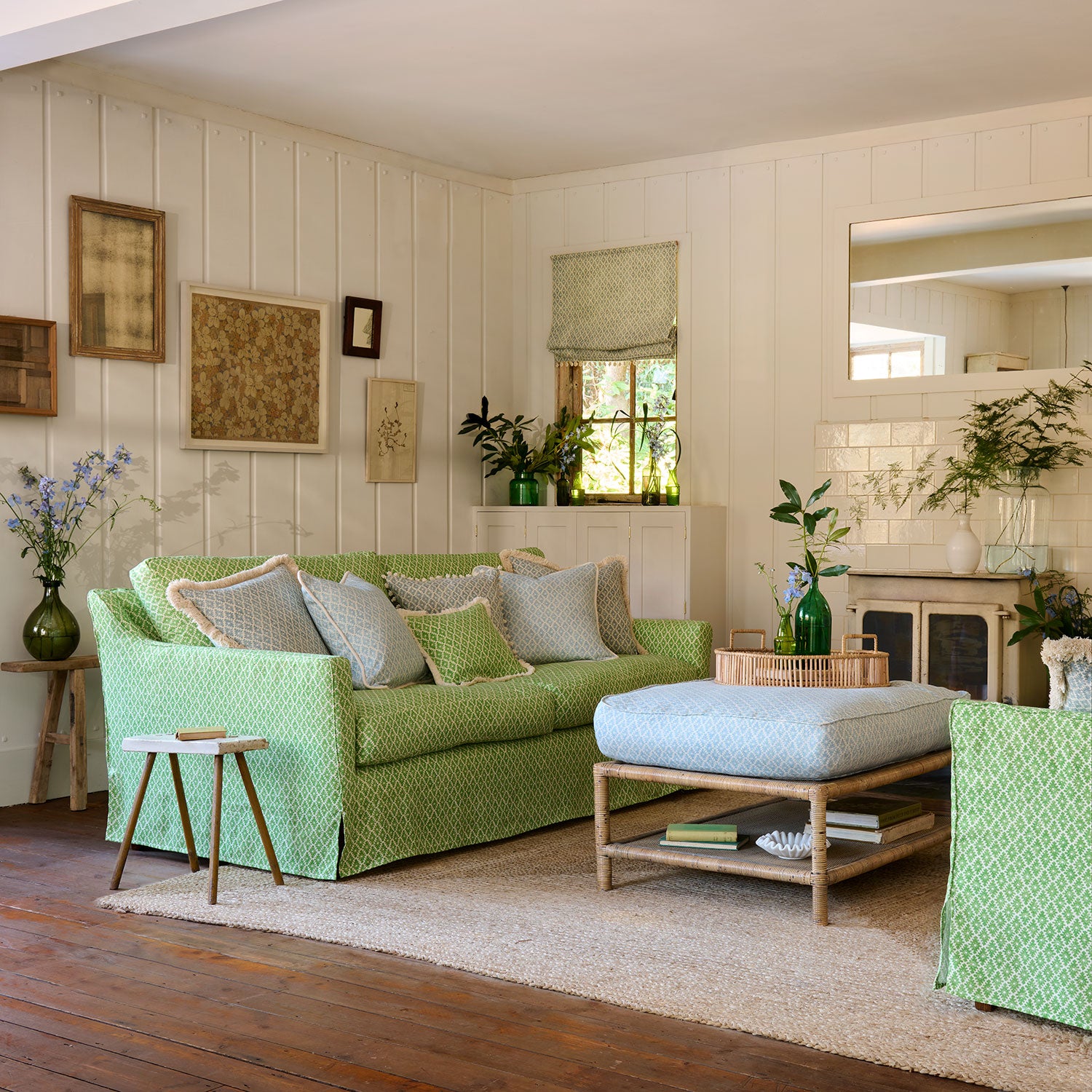 Sofa upholstered in a green and neutral printed linen fabric with a geometric pattern
