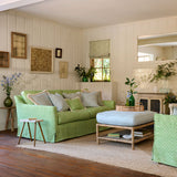 Sofa upholstered in a green and neutral printed linen fabric with a geometric pattern