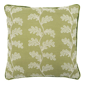 Green embroidered cushion with white leaf pattern.