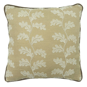 Decorative sand coloured cushion with a off-white leaf pattern.