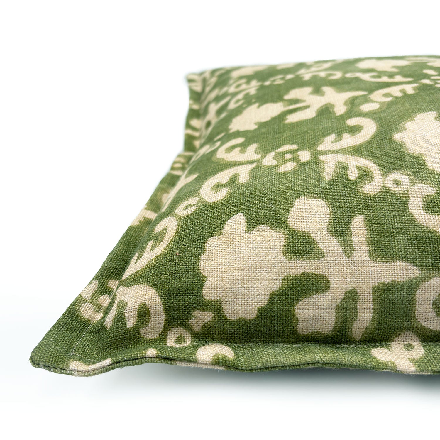 Decorative green pillow with a ivory floral pattern.