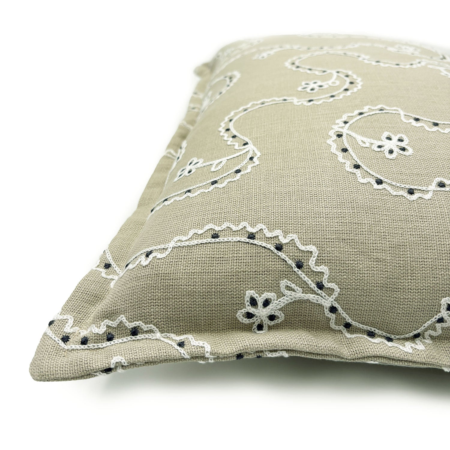 Decorative cushion with a free-flowing floral pattern on a sand coloured background.