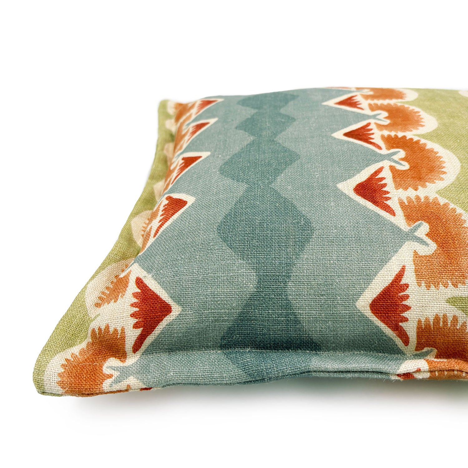 Decorative cushion with geometric pattern in blue, green and ochre.
