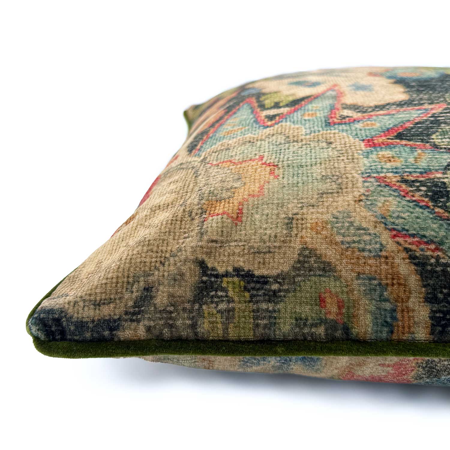 Close-up side view of Linwood cushion in Bizarre Multi, showing the fabric texture and green piping detail.