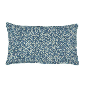 A blue and cream linen cushion with a block print pattern.