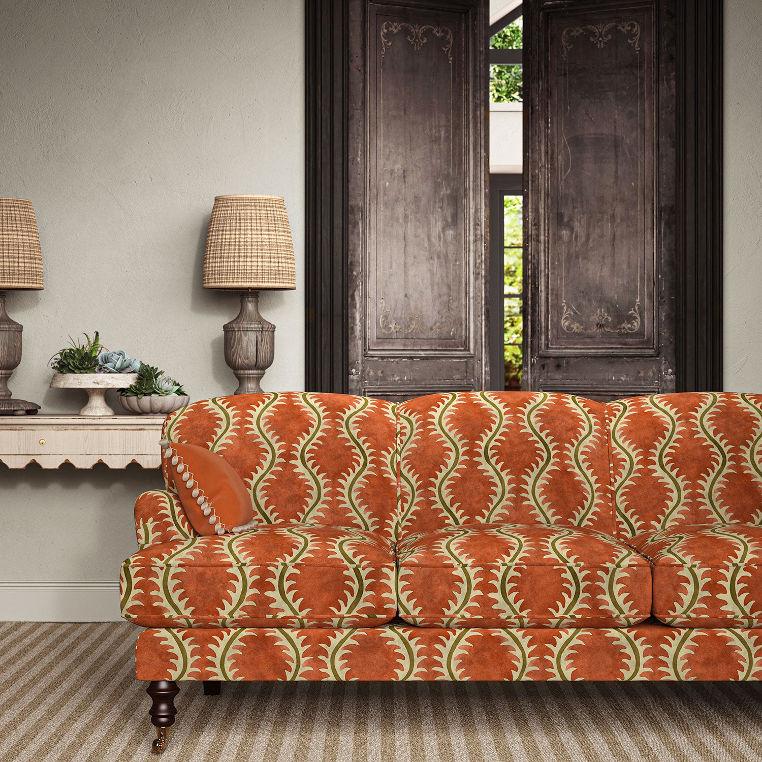 Sofa upholstered in a printed velvet fabric in brown and orange featuring a stylized fern pattern.