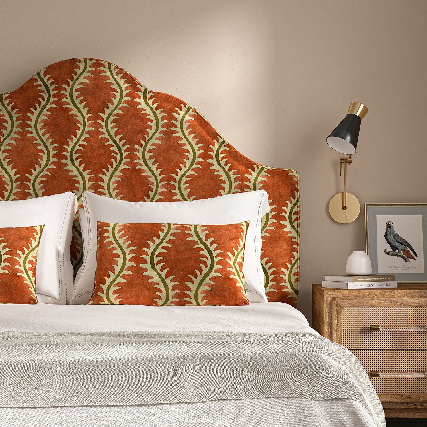 Headboard upholstered in a printed velvet fabric in brown and orange featuring a stylized fern pattern.