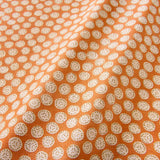 A linen printed with a subtle all-over repeat in orange, cream and black
