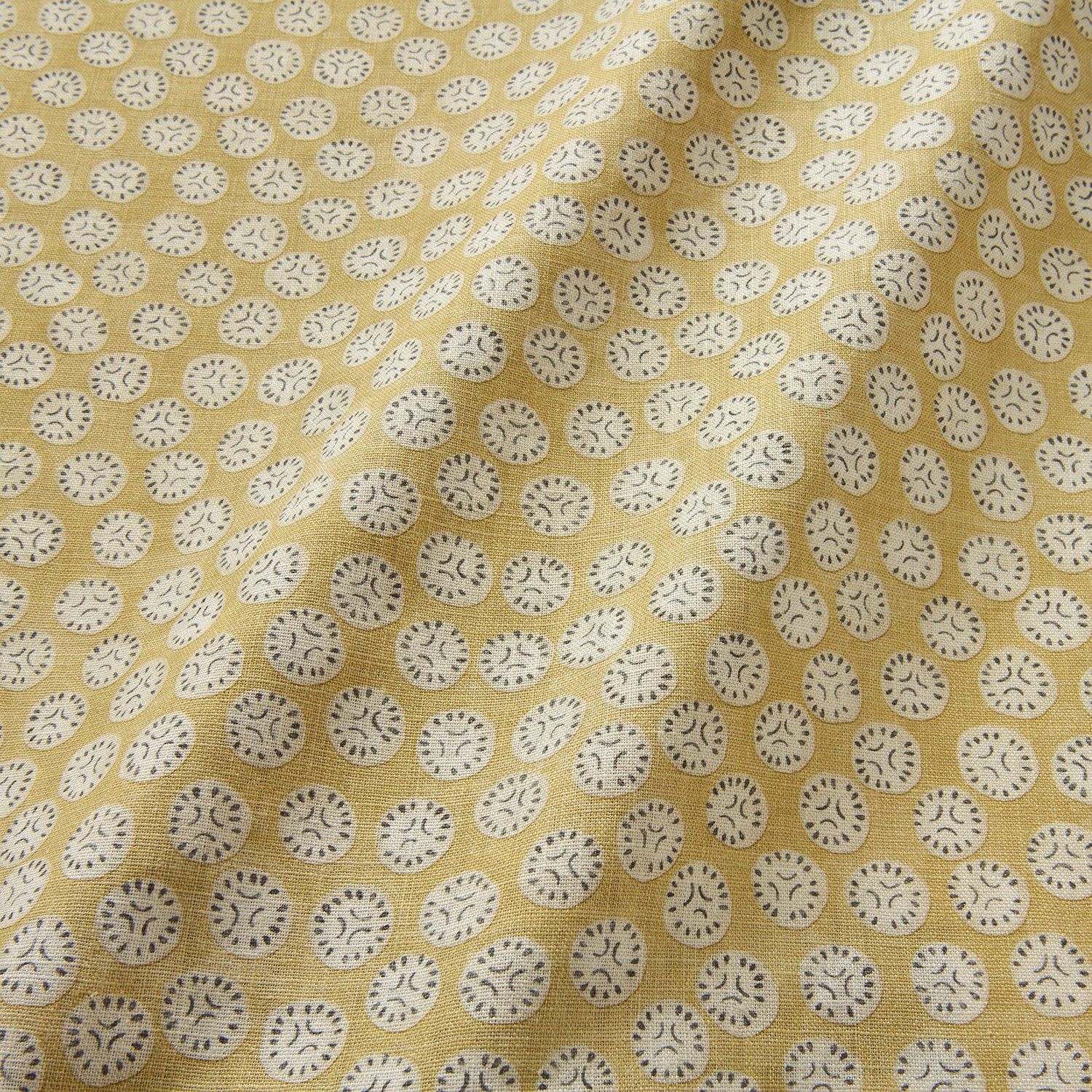 A linen printed with a subtle all-over repeat in yellow, cream and black