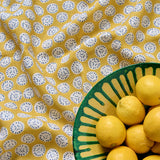 A linen printed with a subtle all-over repeat in yellow, cream and black