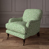 Armchair covered in a linen printed with a subtle all-over repeat in green, cream and black