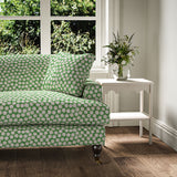 Sofa covered in a linen printed with a subtle all-over repeat in green, cream and black