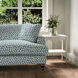 Sofa covered in a linen printed with a subtle all-over repeat in blue, cream and black