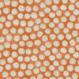 A linen printed with a subtle all-over repeat in orange, cream and black