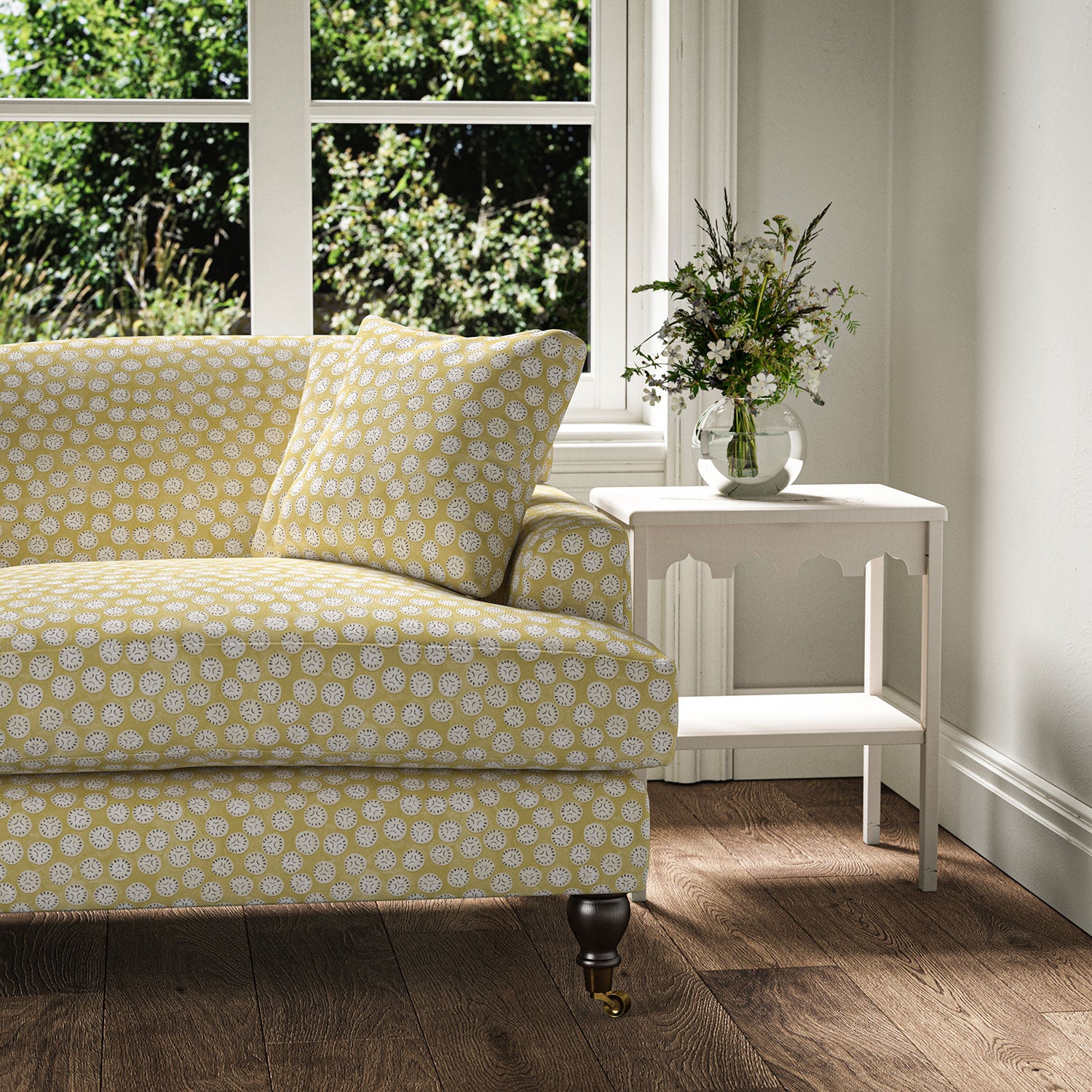 Sofa covered in a linen printed with a subtle all-over repeat in yellow, cream and black