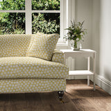 Sofa covered in a linen printed with a subtle all-over repeat in yellow, cream and black