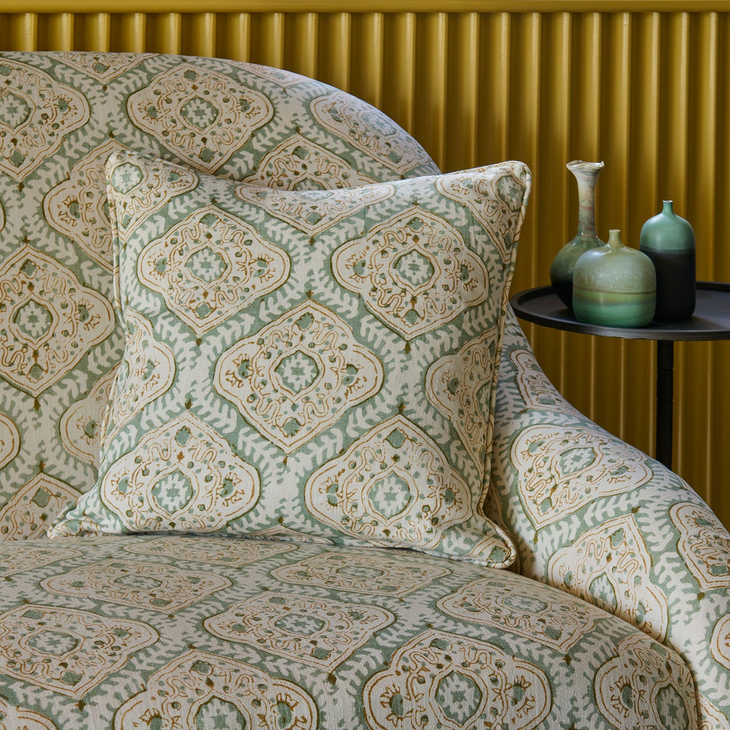 Sofa & cushion covered in a linen print with a handcrafted feel in pale green