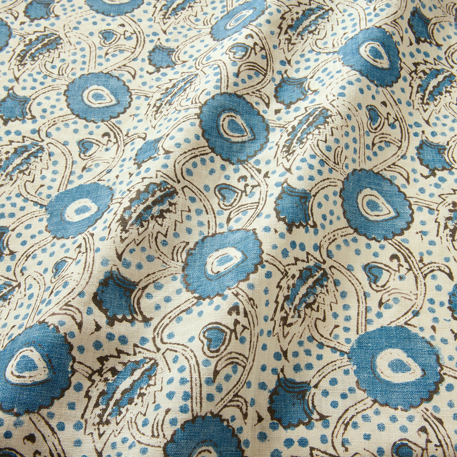 A stylised floral printed on linen fabric in blue, black and cream