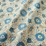 A stylised floral printed on linen fabric in blue, black and cream