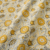 A stylised floral printed on linen fabric in yellow, black and cream