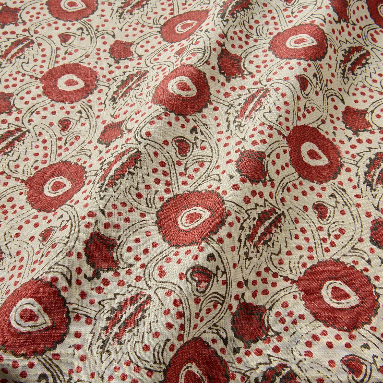 A stylised floral printed on linen fabric in red, black and cream