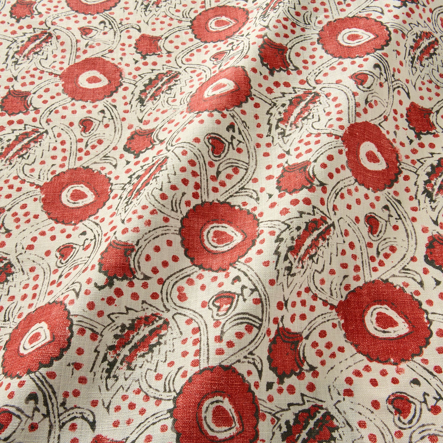 A stylised floral printed on linen fabric in red, black and cream