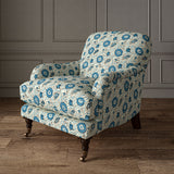 Armchair covered with a stylised floral printed on linen fabric in blue, black and cream