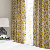 Armchair covered with a stylised floral printed on linen fabric in yellow, black and cream