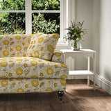Sofa covered with a stylised floral printed on linen fabric in yellow, black and cream