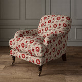 Armchair covered with a stylised floral printed on linen fabric in red, black and cream