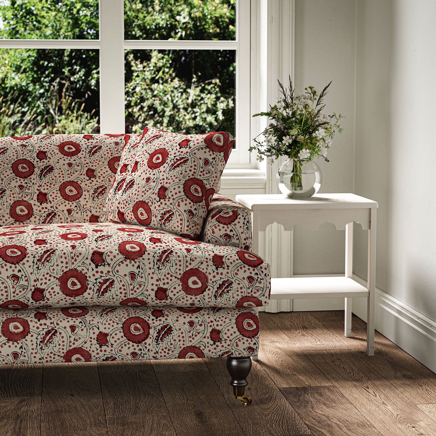 Sofa covered with a stylised floral printed on linen fabric in red, black and cream