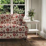 Sofa covered with a stylised floral printed on linen fabric in red, black and cream