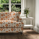 Sofa covered with a stylised floral printed on linen fabric in red, blue and cream
