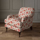 Armchair covered with a stylised floral printed on linen fabric in red, black and cream