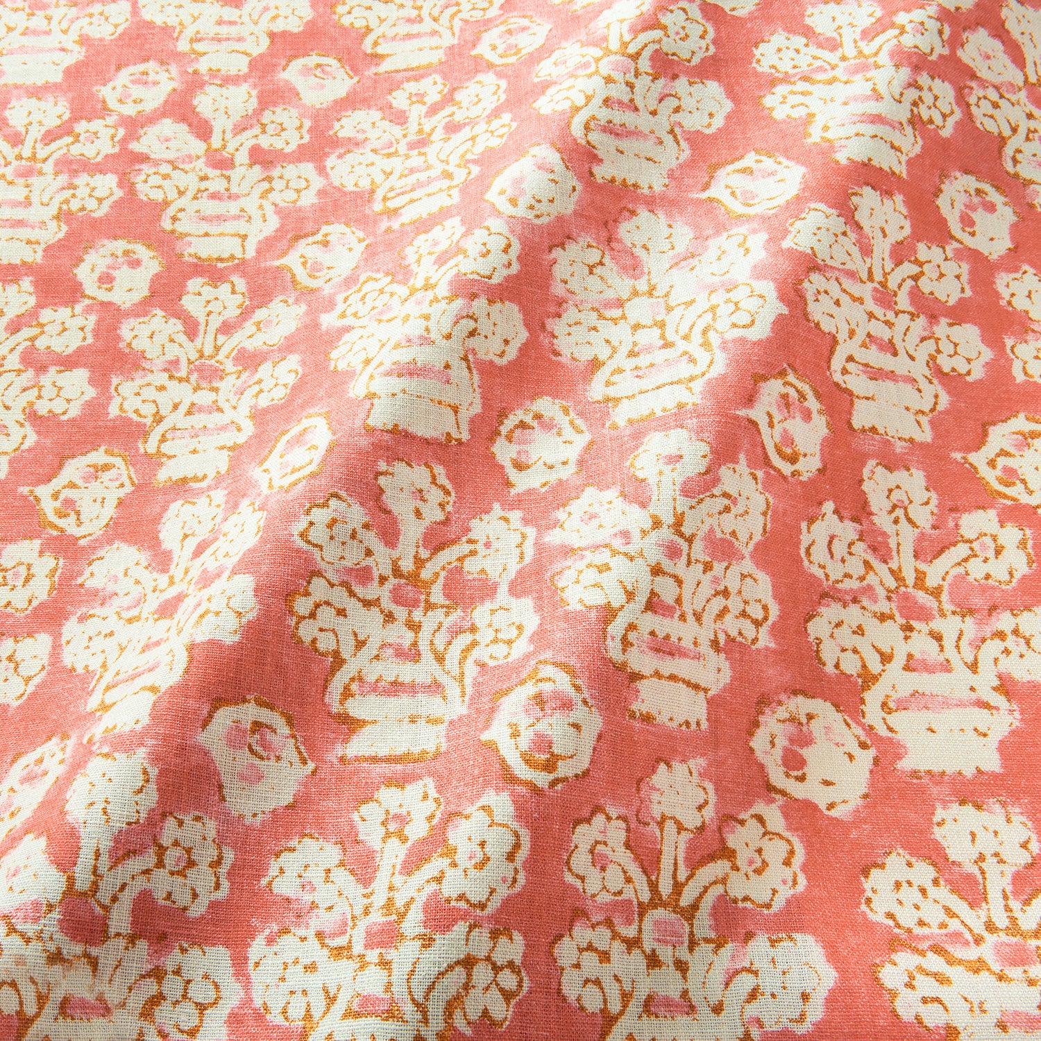 A jolly printed linen fabric in pink, orange and cream
