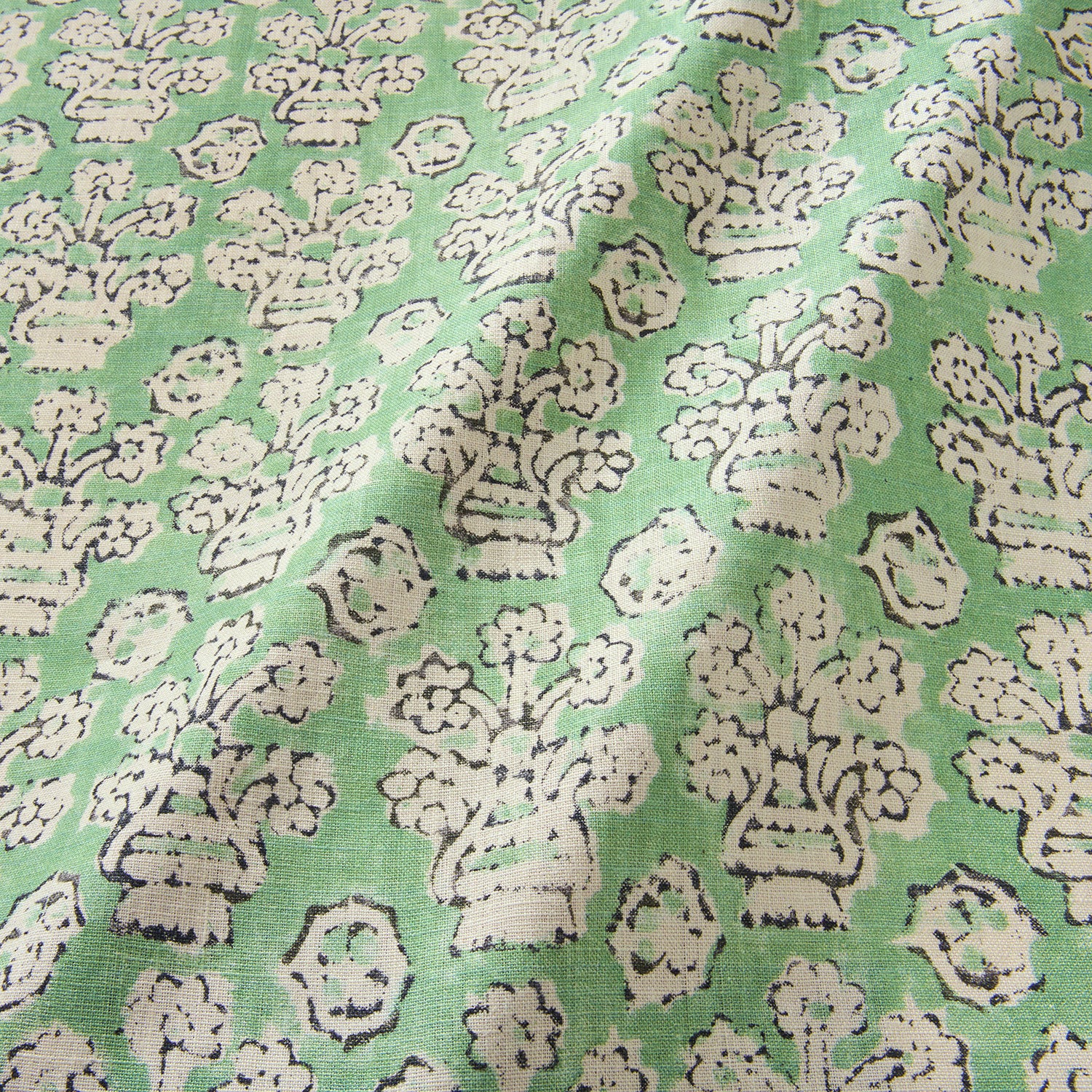 A jolly printed linen fabric in green, black and cream