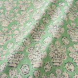 A jolly printed linen fabric in green, black and cream