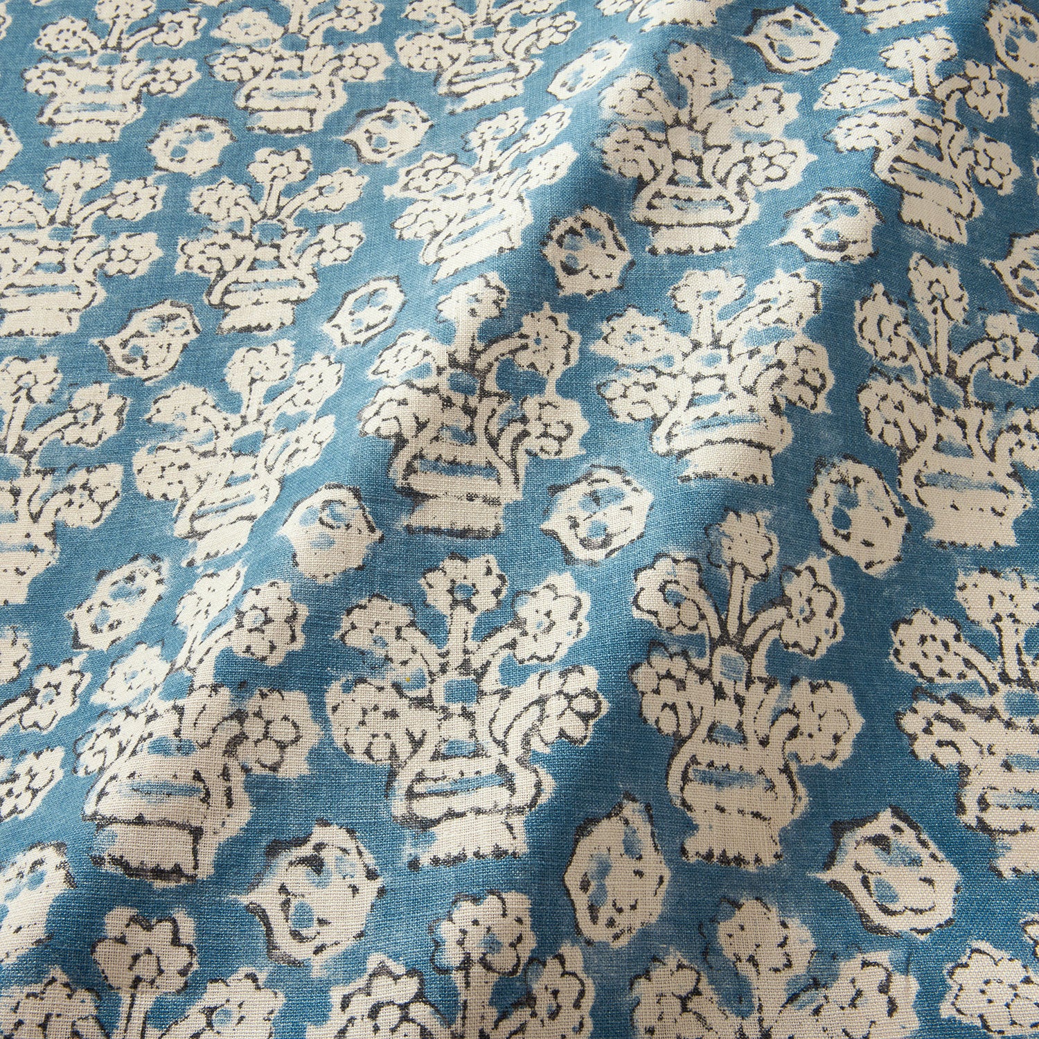 A jolly printed linen fabric in blue, black and cream