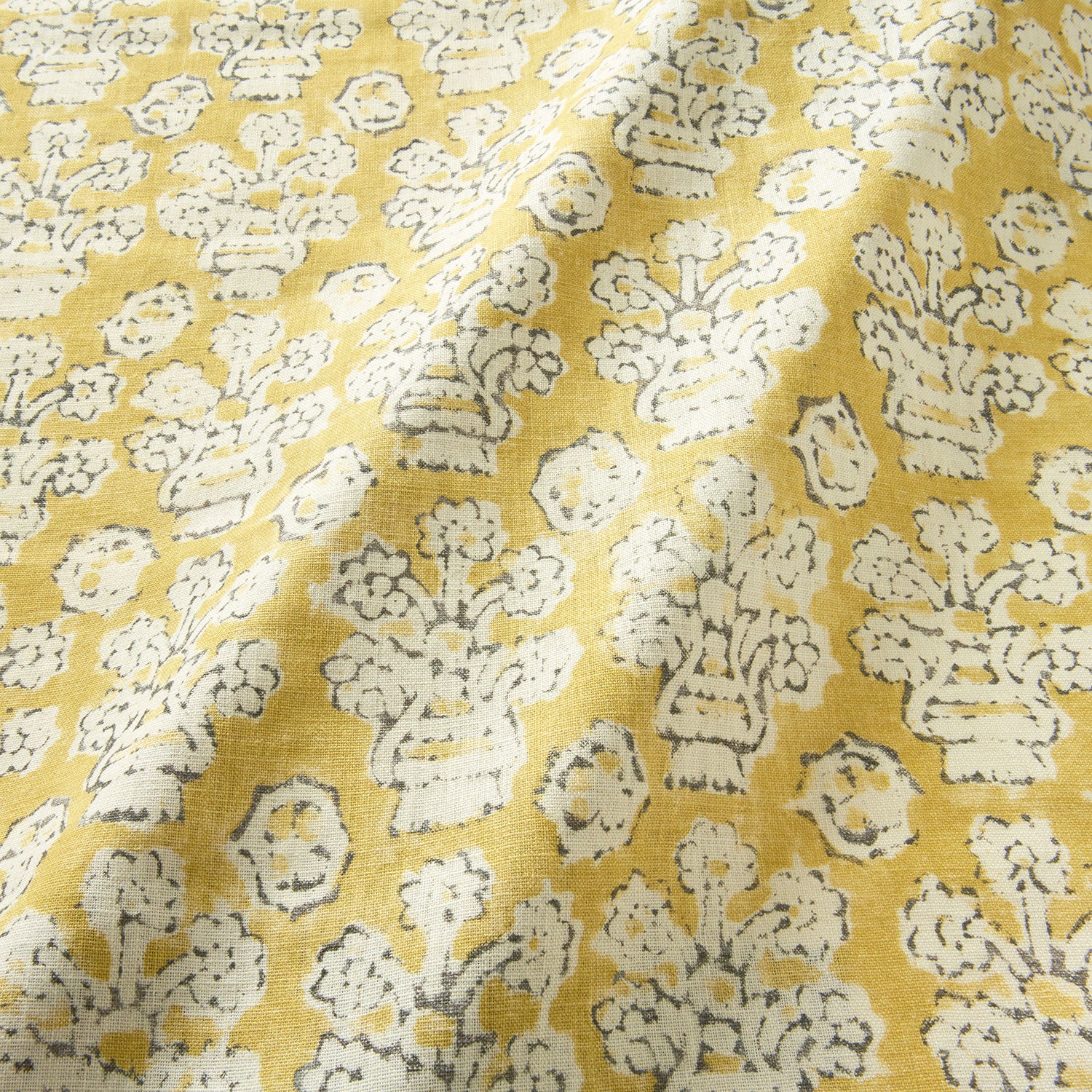 A jolly printed linen fabric in yellow, black and cream