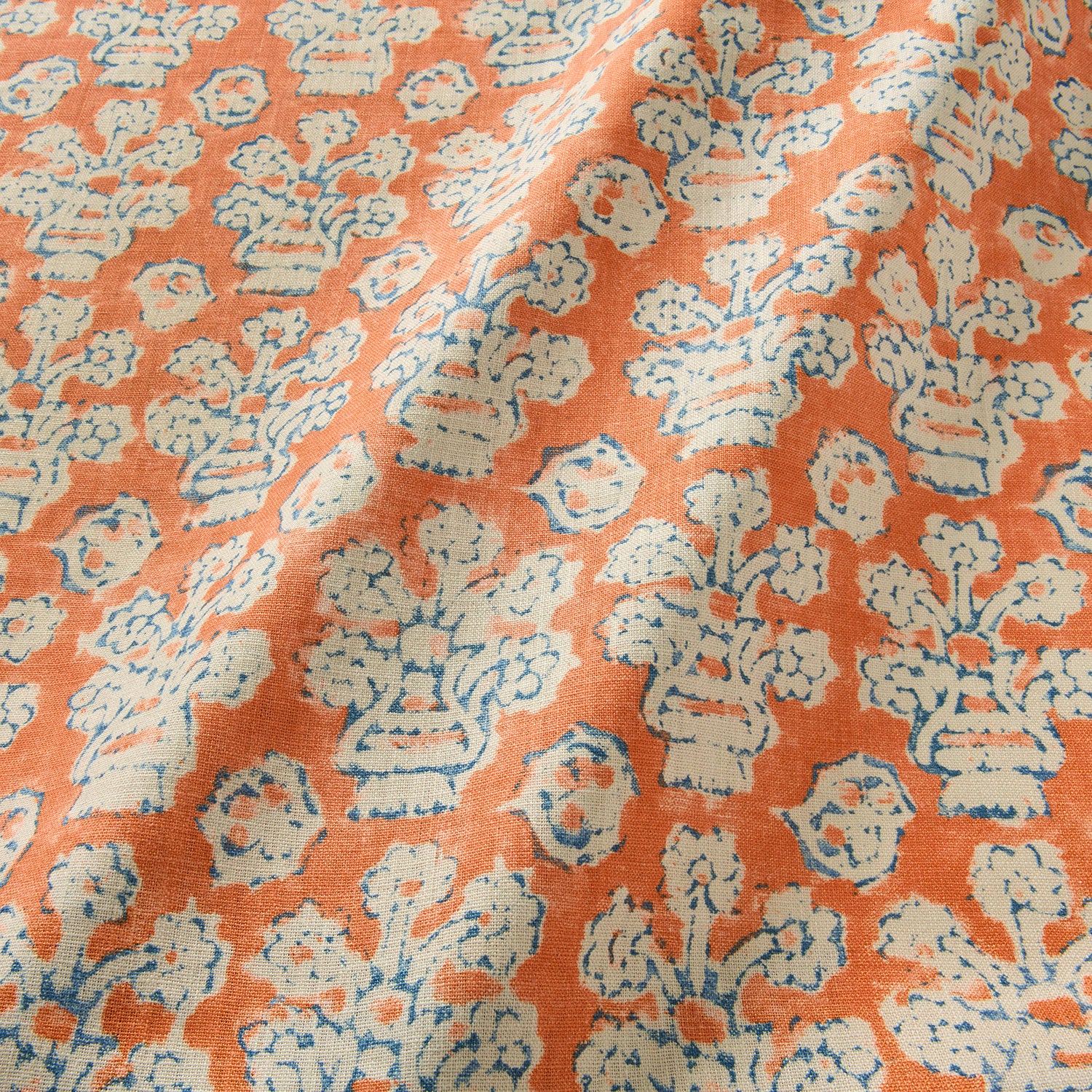A jolly printed linen fabric in orange, blue and cream