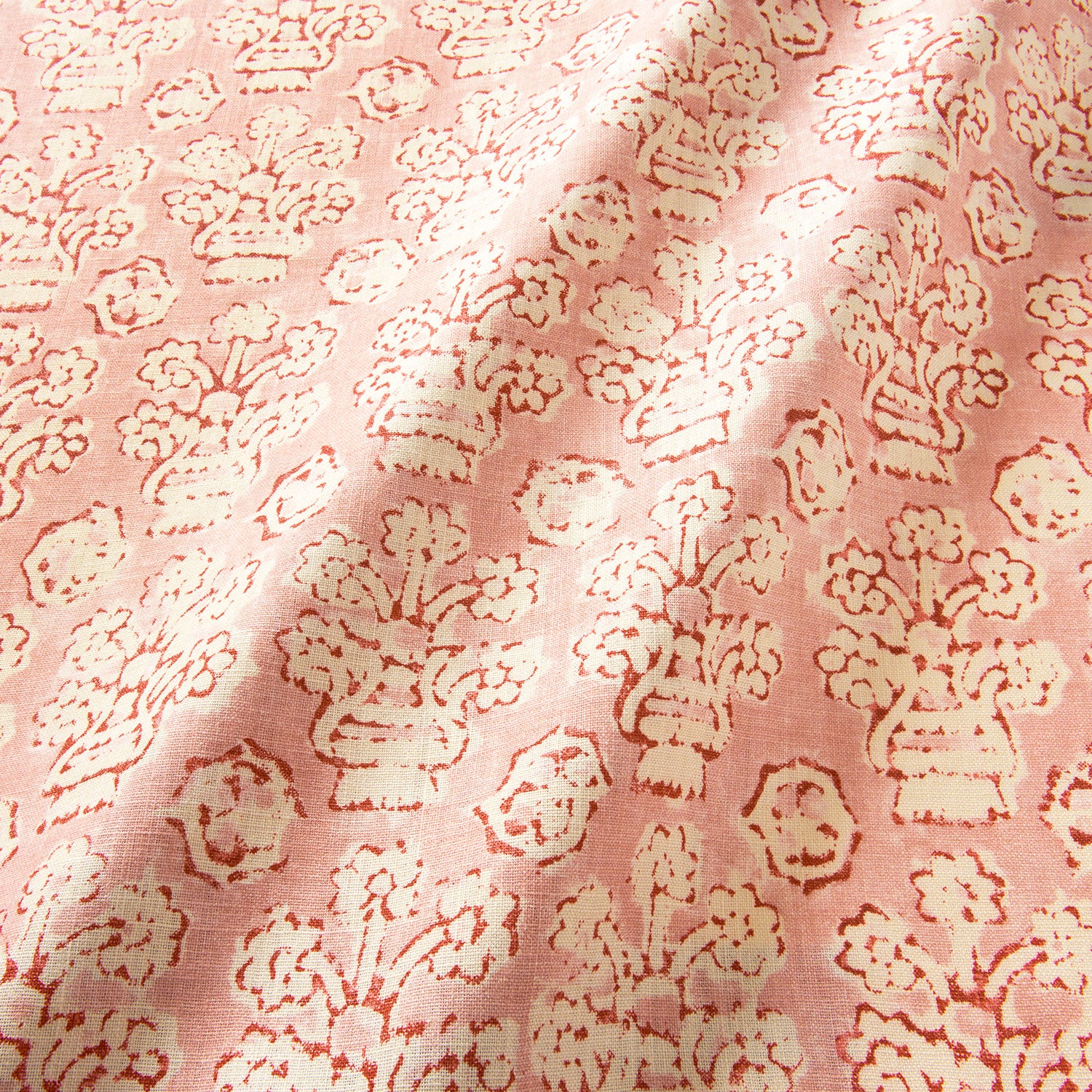 A jolly printed linen fabric in pink, red and cream