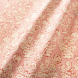 A jolly printed linen fabric in pink, red and cream