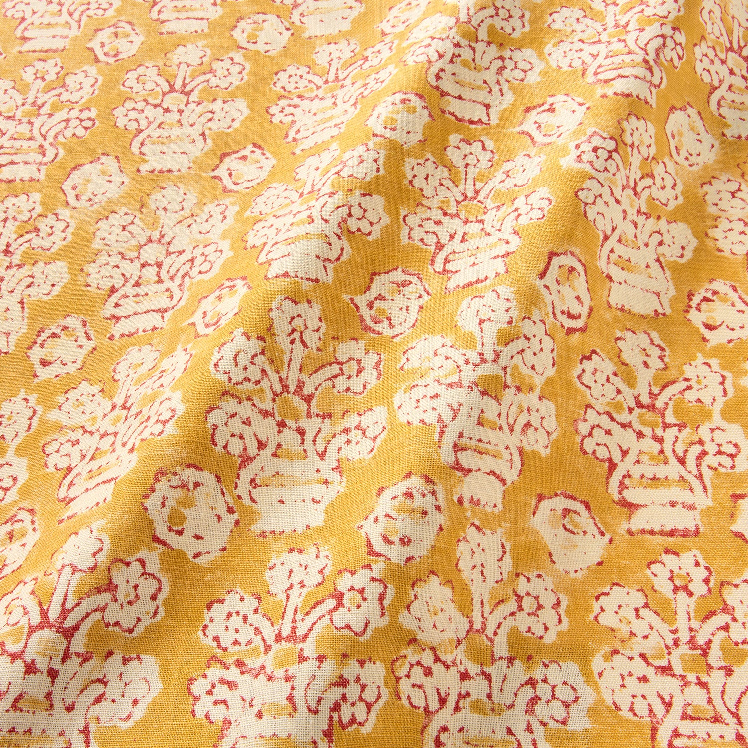 A jolly printed linen fabric in yellow, red and cream