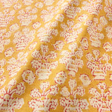 A jolly printed linen fabric in yellow, red and cream