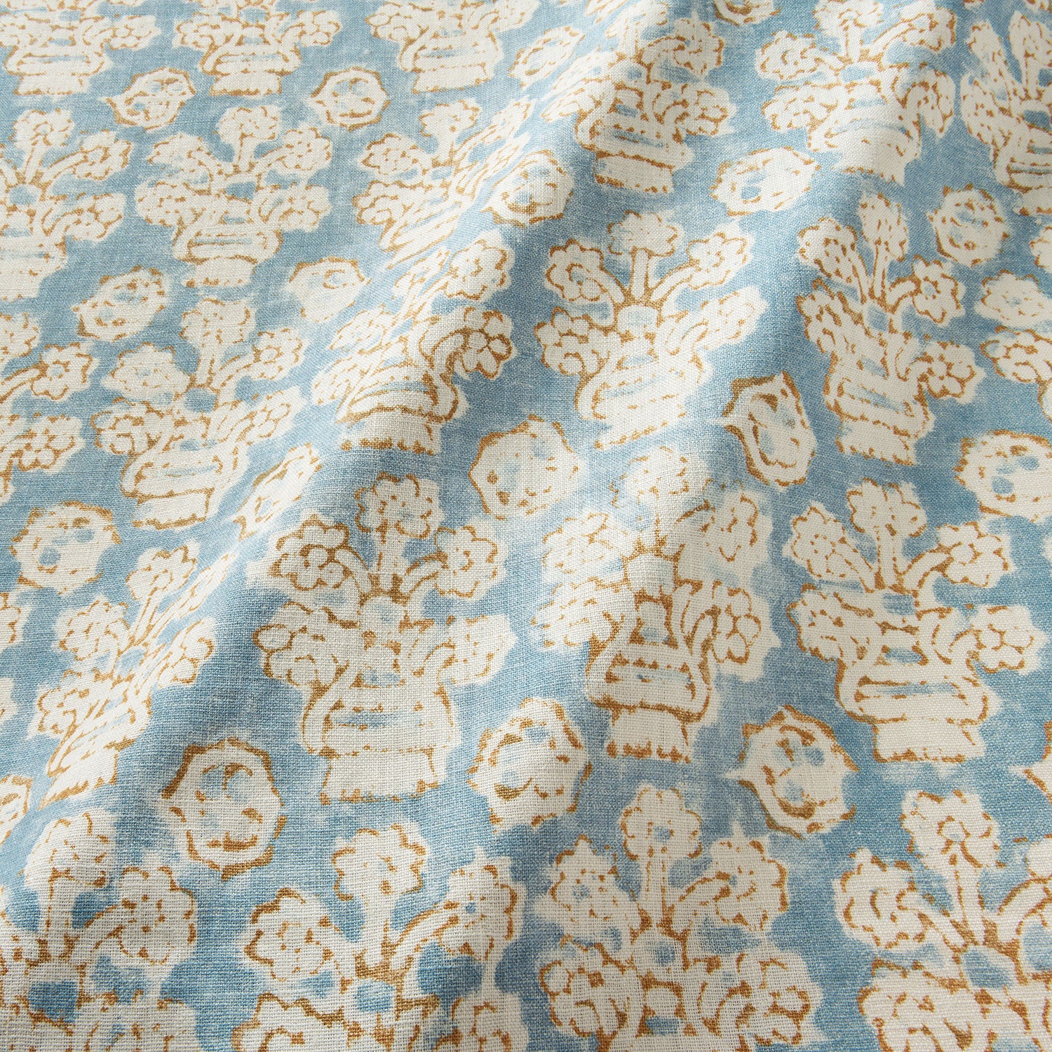 A jolly printed linen fabric in blue, yellow and cream