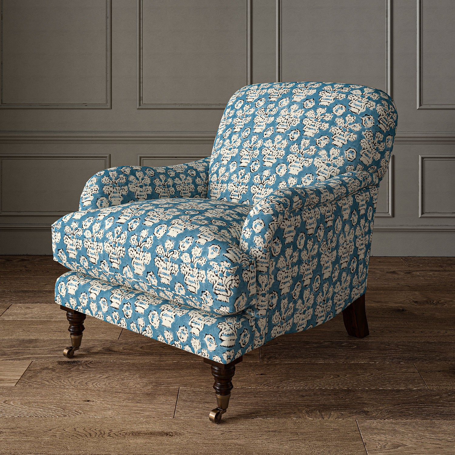 Armchair covered in a jolly printed linen fabric in blue, black and cream