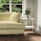 Sofa covered in a jolly printed linen fabric in yellow, black and cream