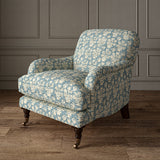 Armchair covered in a jolly printed linen fabric in blue, black and cream